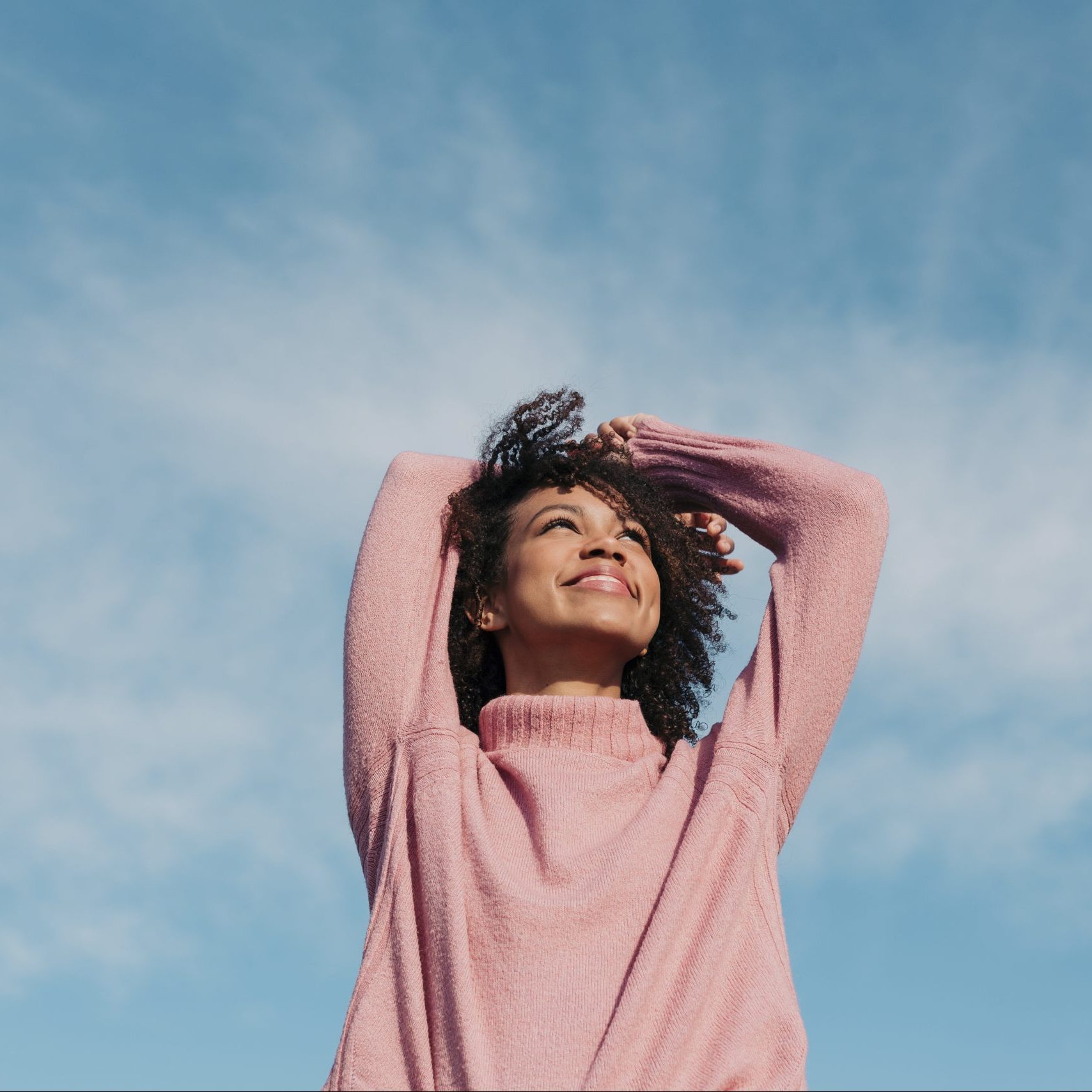 Portrait Of Happy Young Woman Enjoying Sunlight