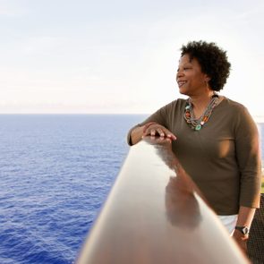 Woman on cruise ship deck looking into the ocean