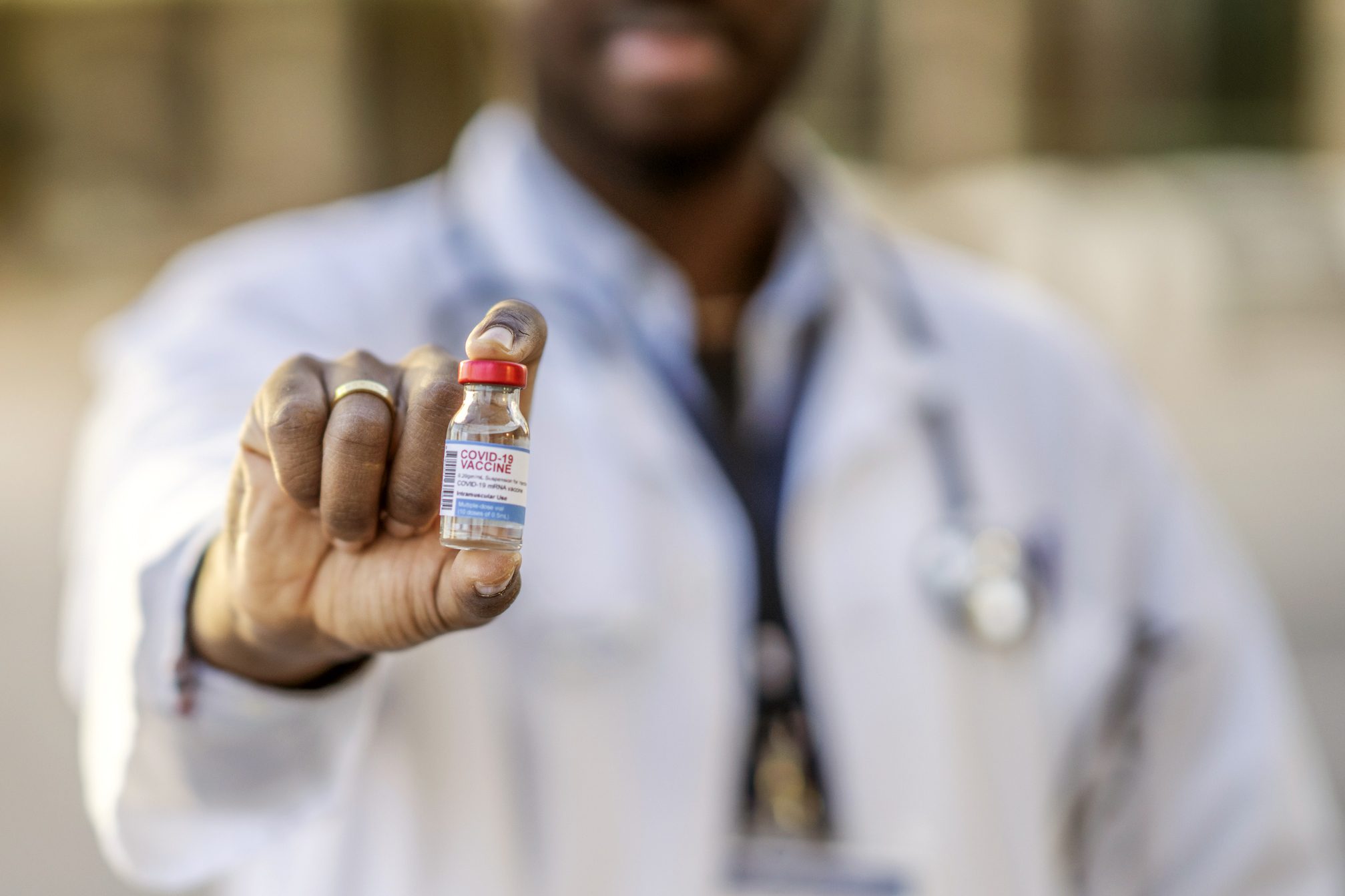 doctor holding a covid 19 vaccine vial