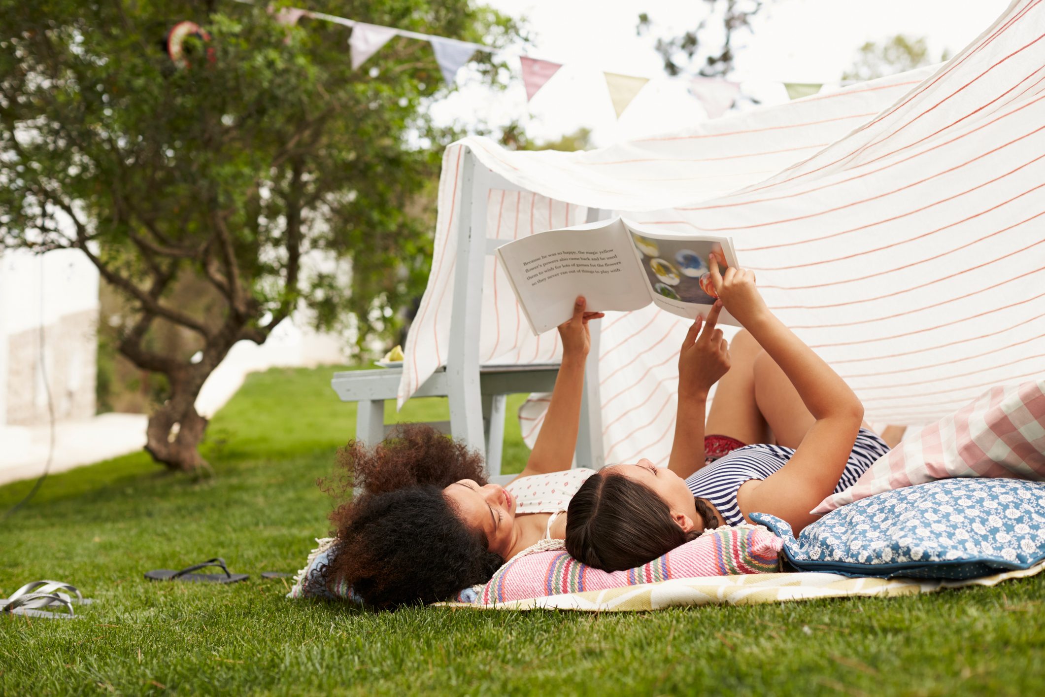 Mother And Daughter Playing In Home Made Garden Den