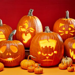 group of Halloween Jack O Lanterns Carved From Printable Templates; orange background