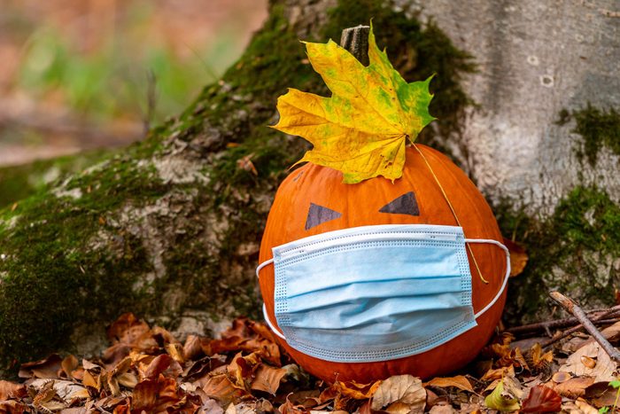 Jack O' Lantern wearing facial mask. Halloween theme.