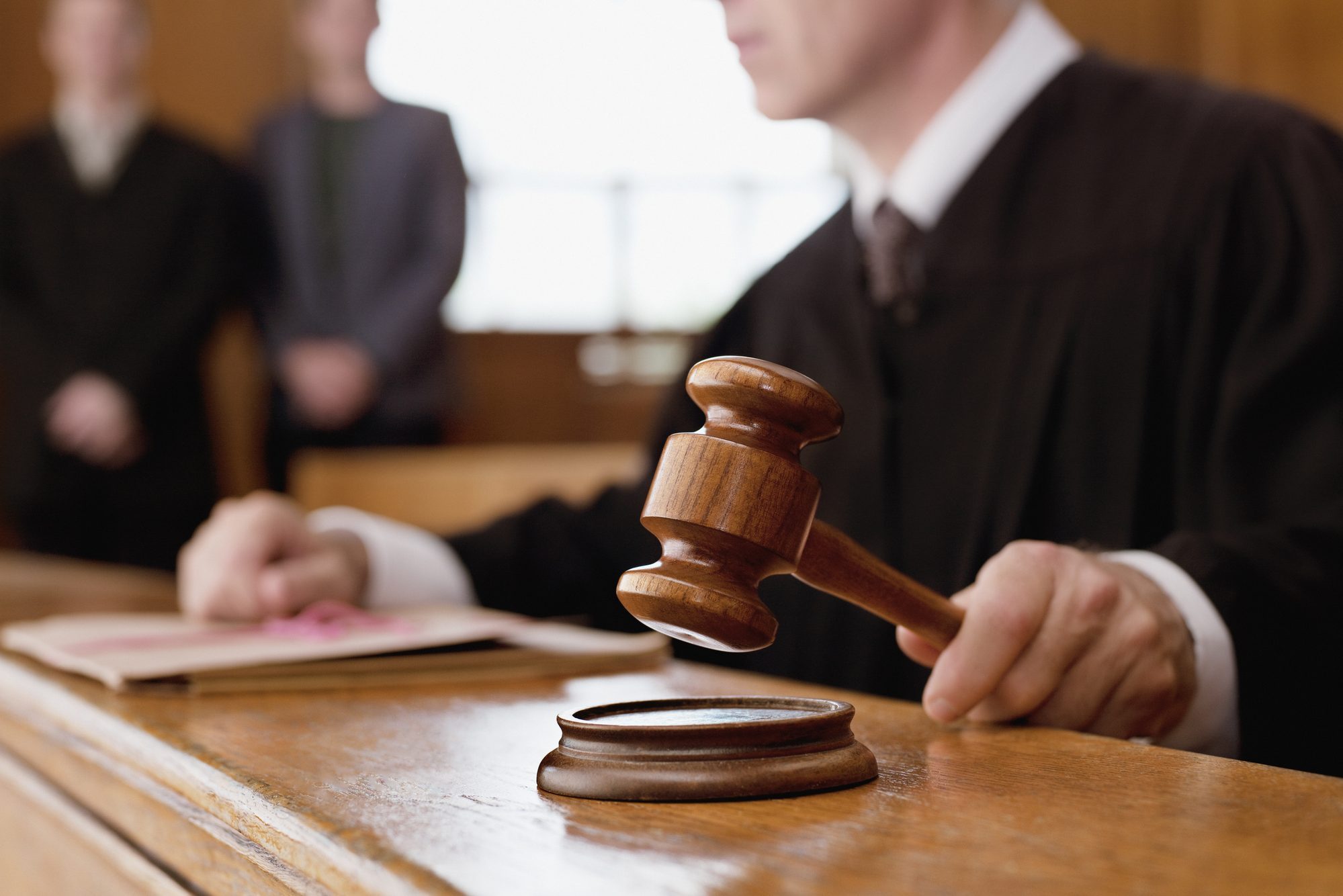 Judge holding gavel in courtroom