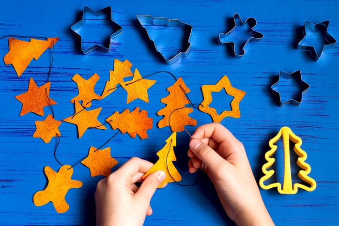 Child making decorations of orange peel for Christmas