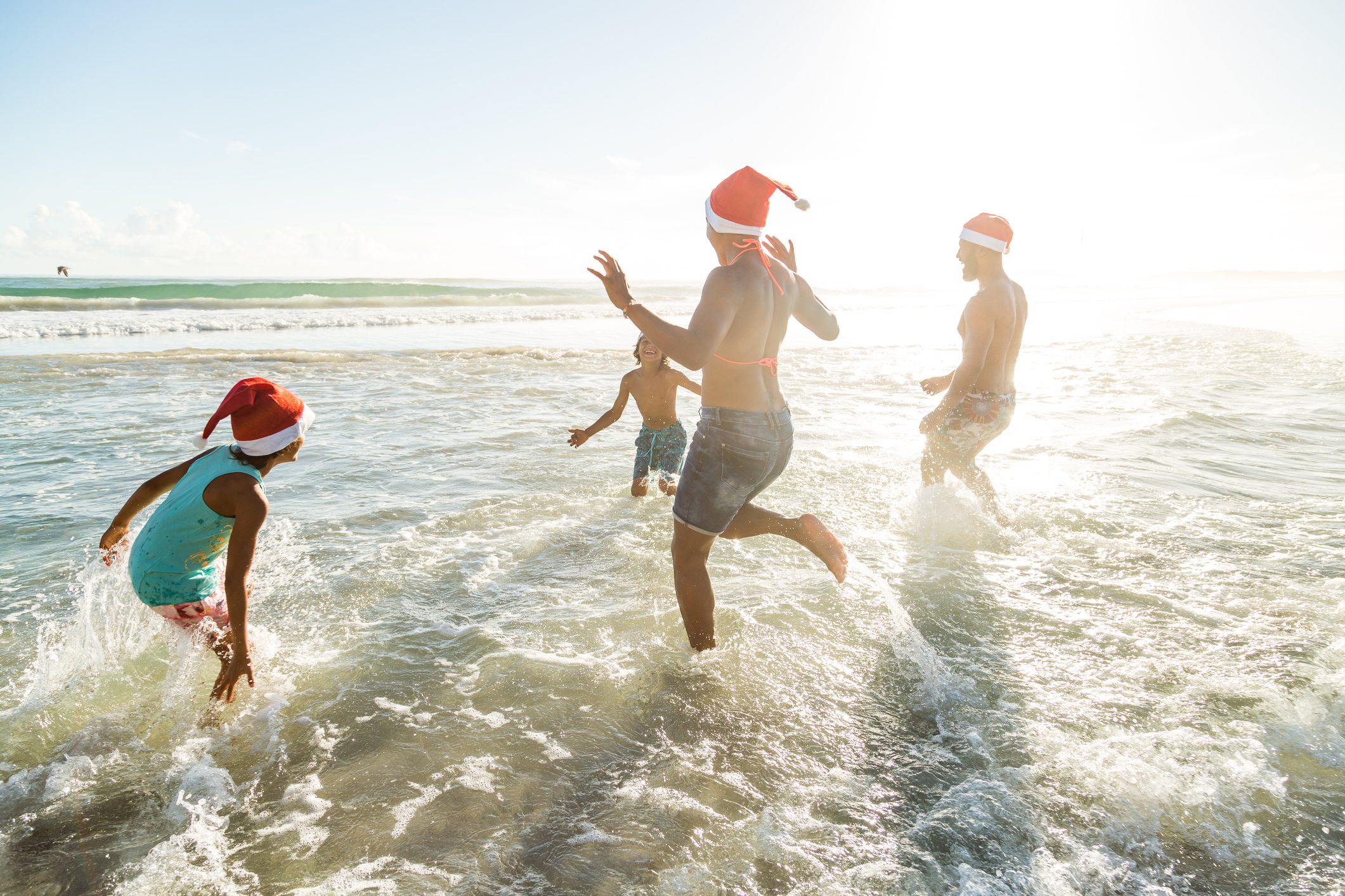 Family enjoying Christmas together on the beach