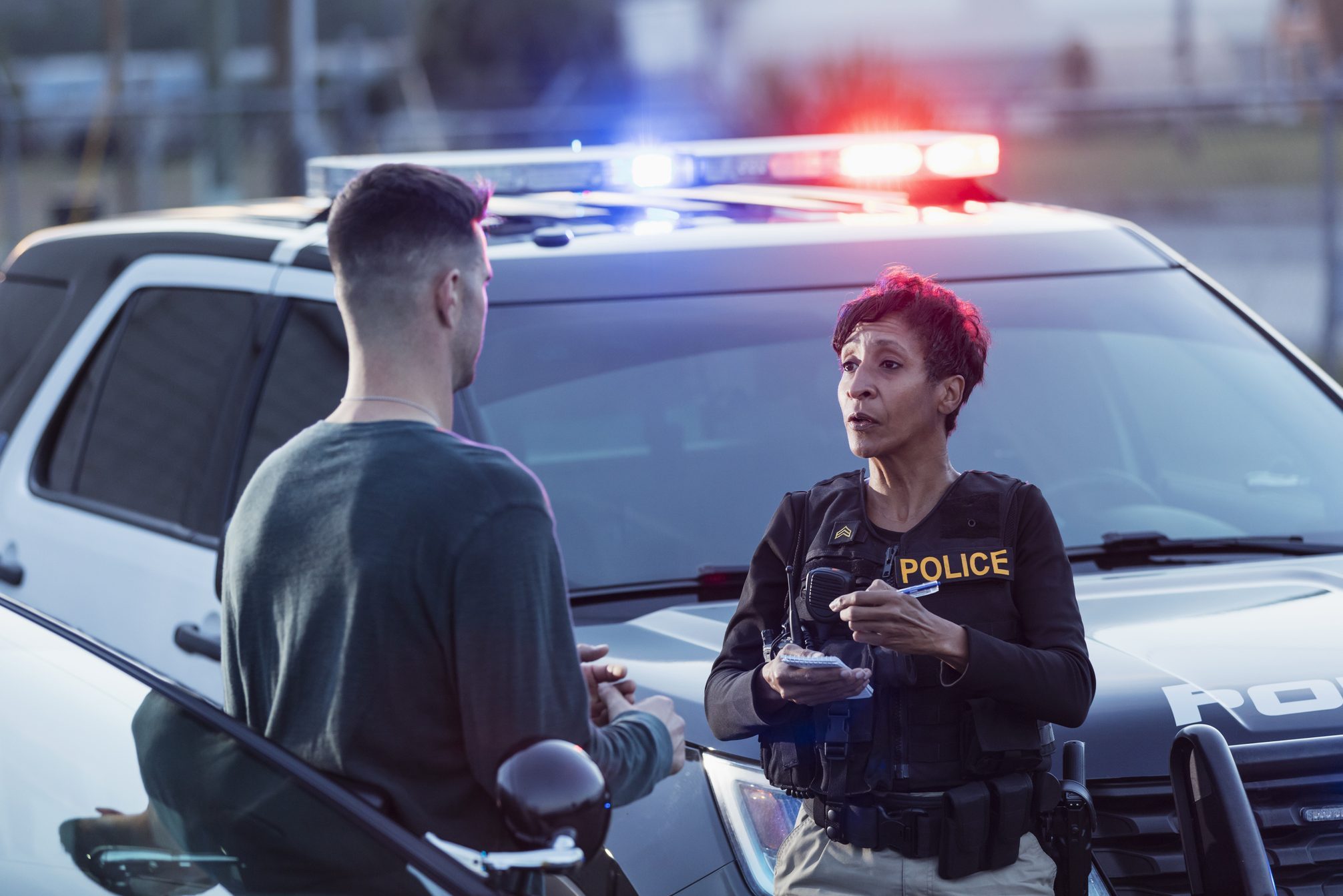 Policewoman taking a statement from young man