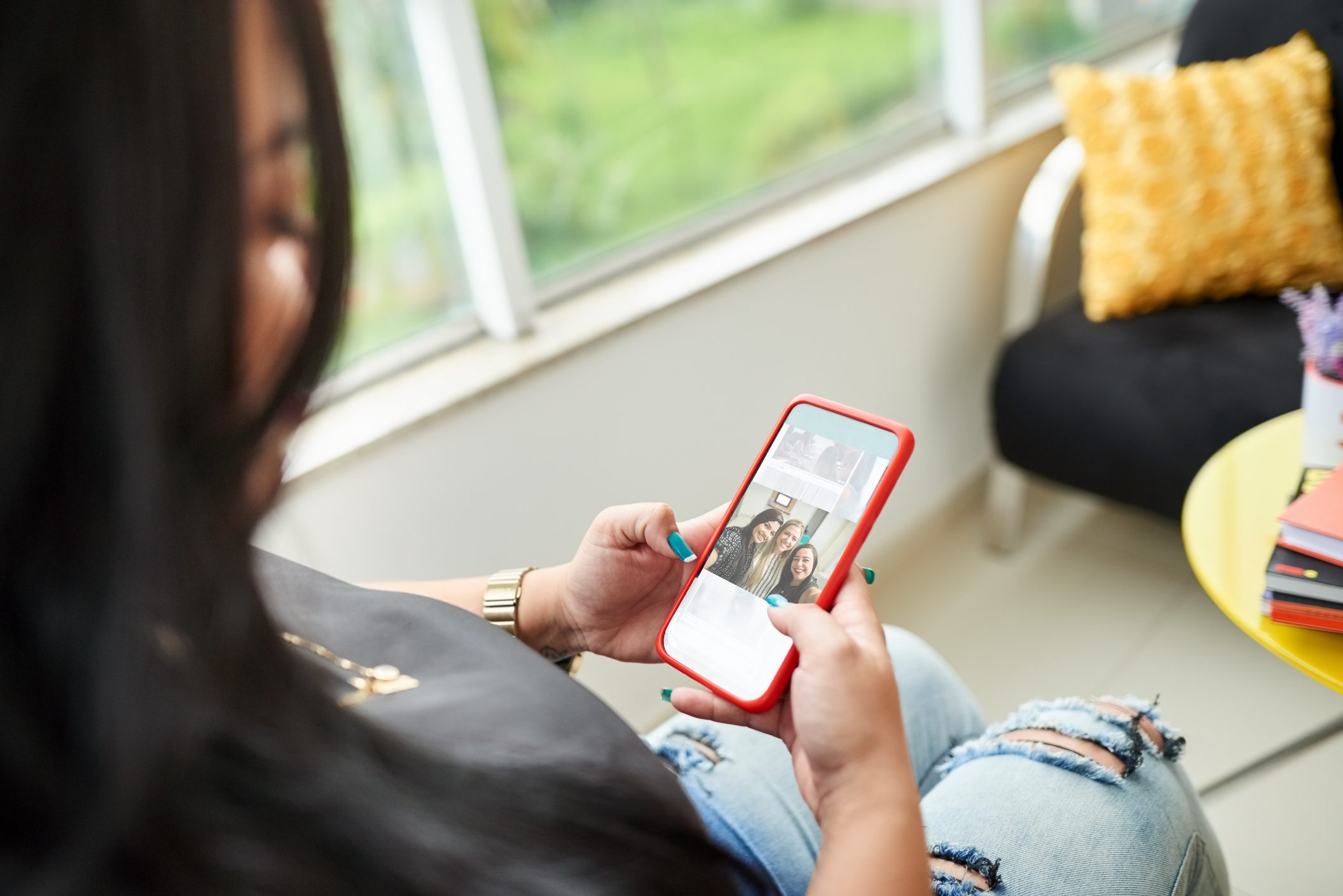 young woman looking through photos on smartphone device