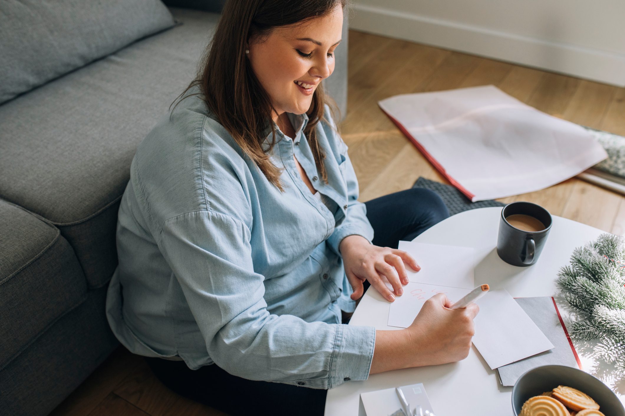 young woman writing down goals during the holidays