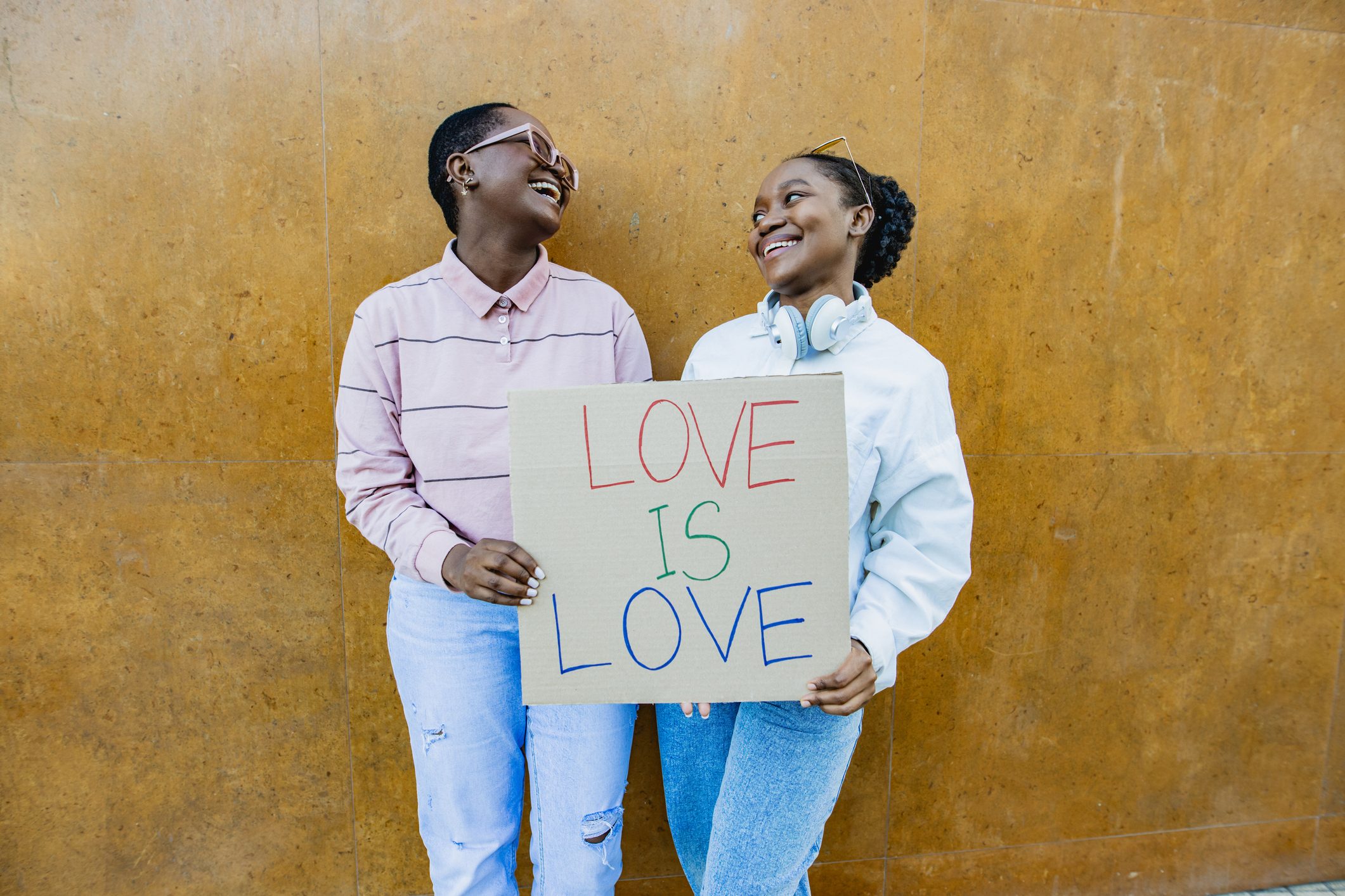 two girls holding a sign that reads "love is love"