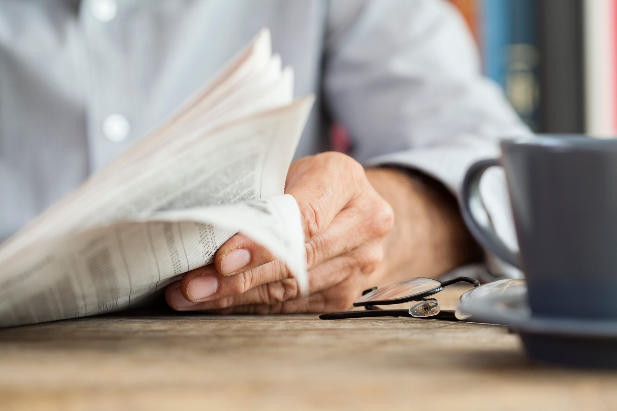 Man newspaper reading on table