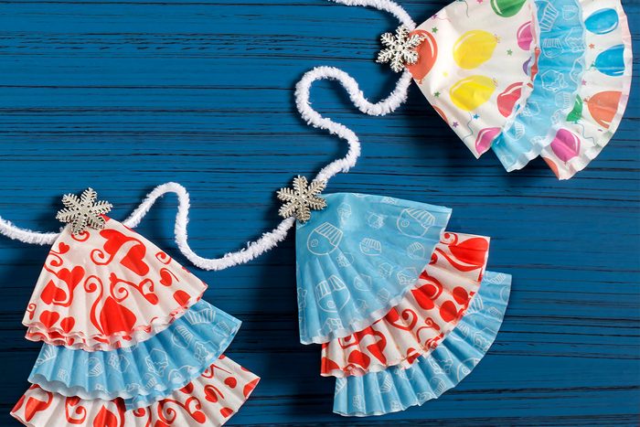 Garland with Christmas trees from paper forms for muffins