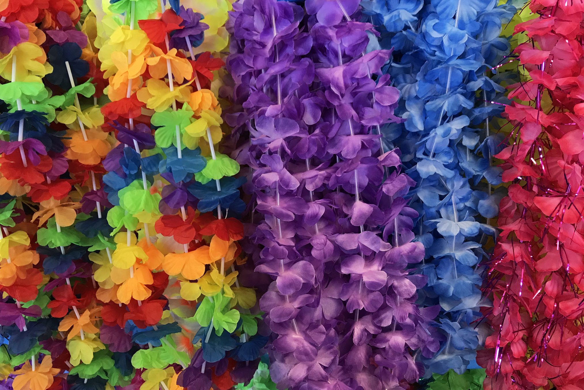 Bunch of colorful fabric lei or floral garland on display for retail sale