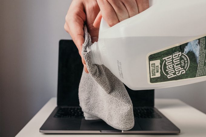 wetting a microfiber cloth with distilled water