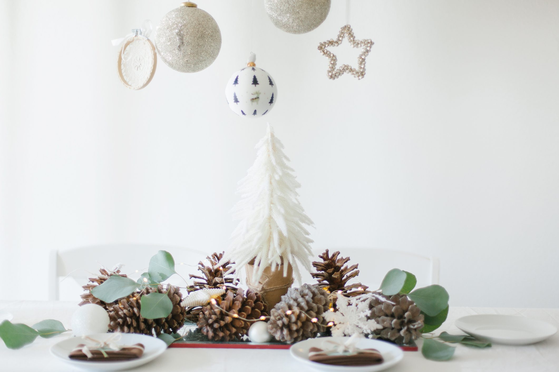 White and brown Christmas table decorations with eucalyptus leaves
