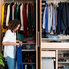 Woman clearing out her wardrobe at home