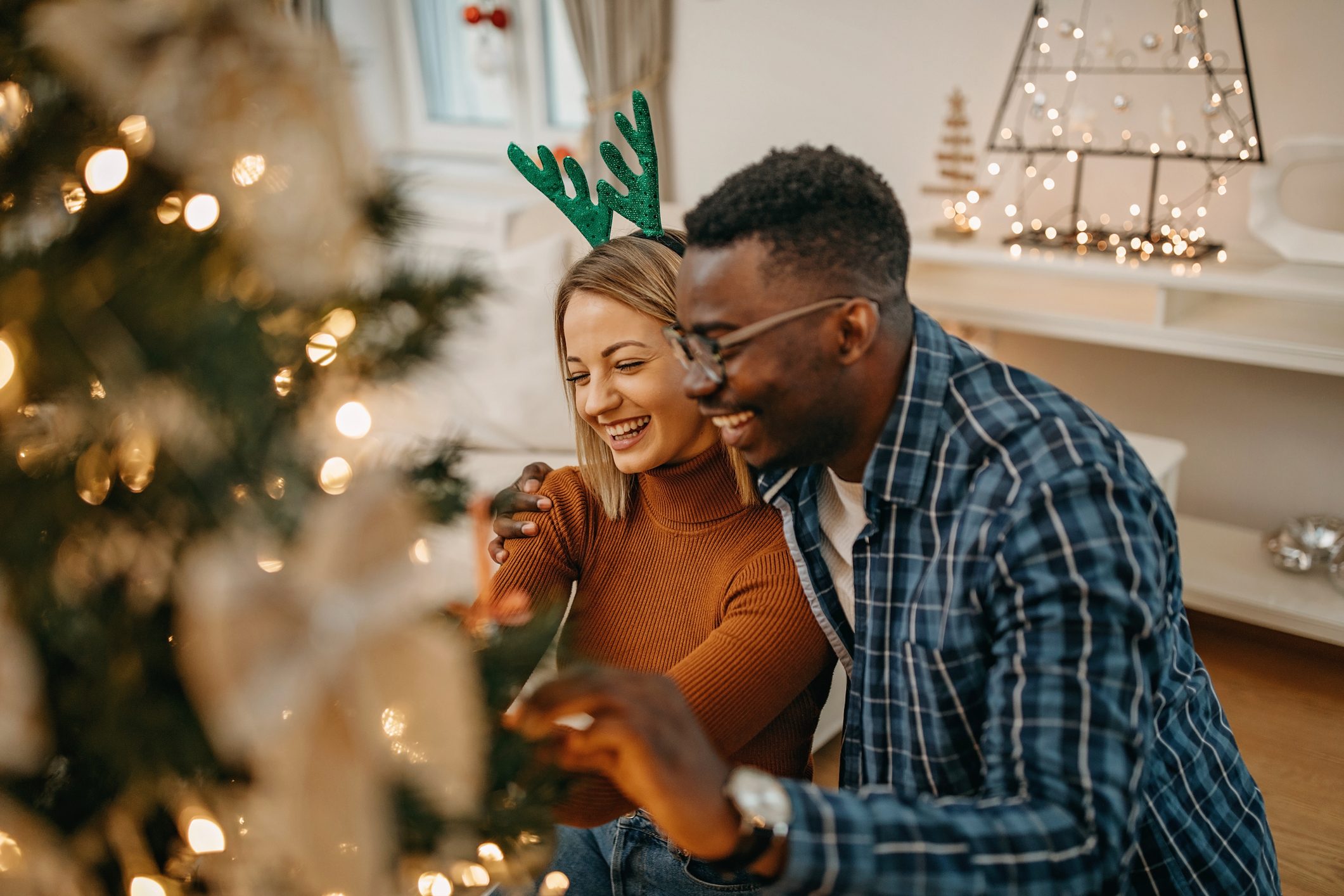 Couple decorating for christmas smiling