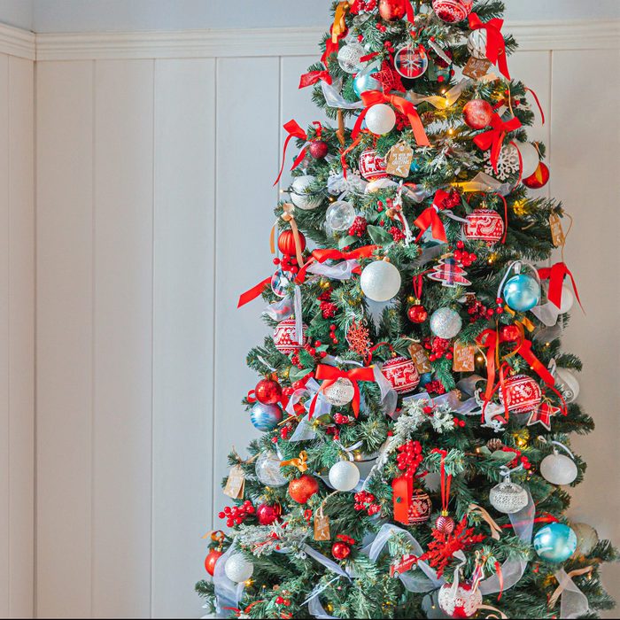 Classic Christmas New Year decorated New year tree with red and white ornament decorations toy and ball