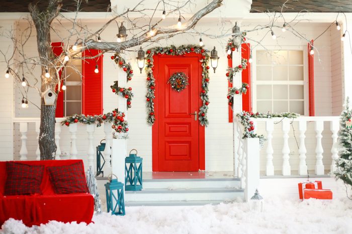 front of a house decorated for christmas