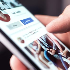 close up of a person scrolling on someone's facebook profile on smartphone