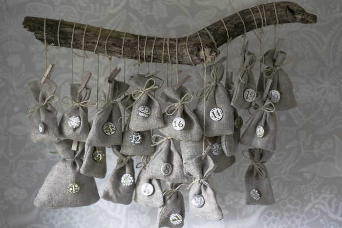 DIY Christmas advent calendar hanging from driftwood
