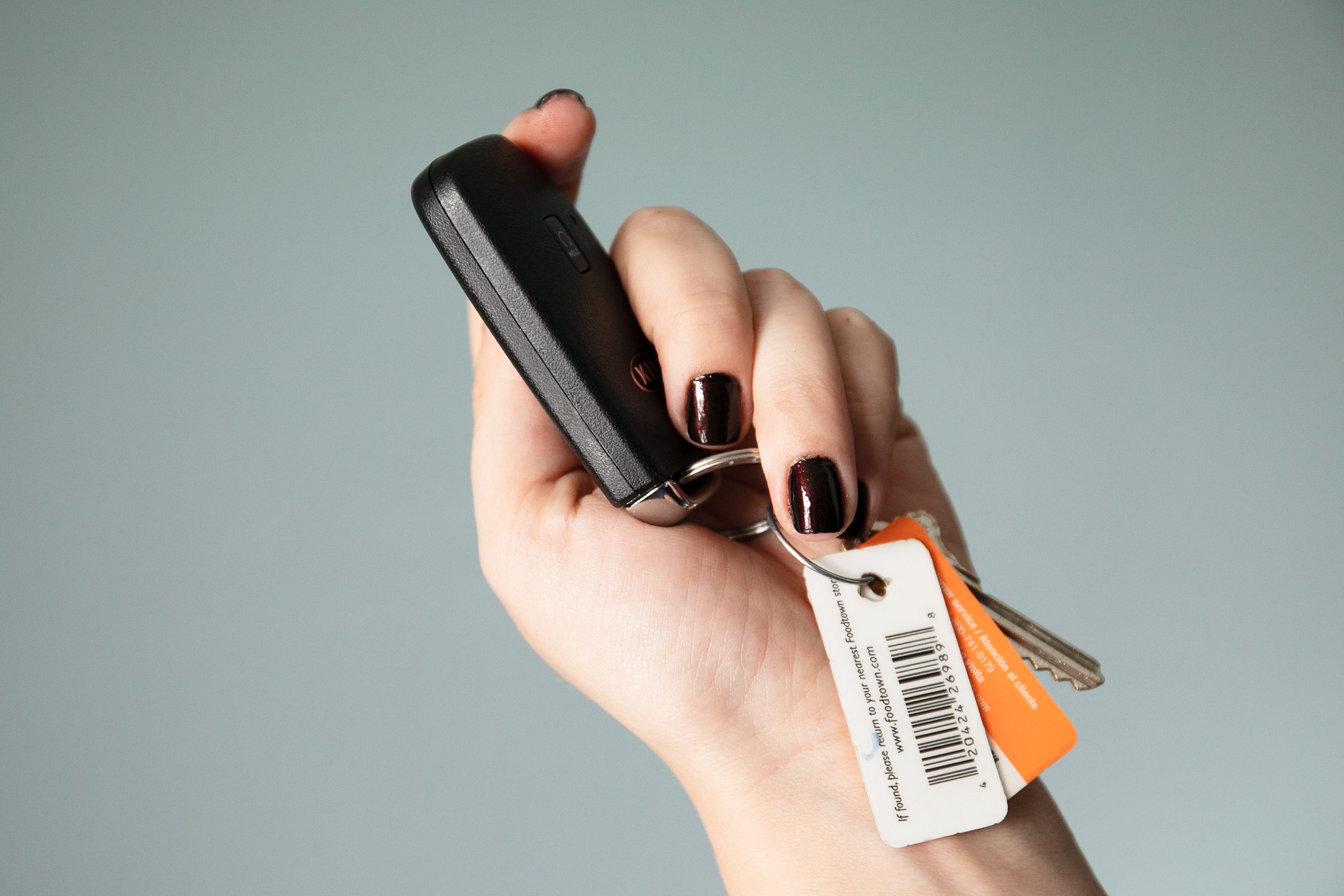 holding a key fob, observing the seams of a car key fob