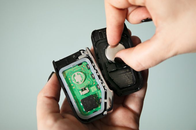 replacing car key battery while holding open key fob