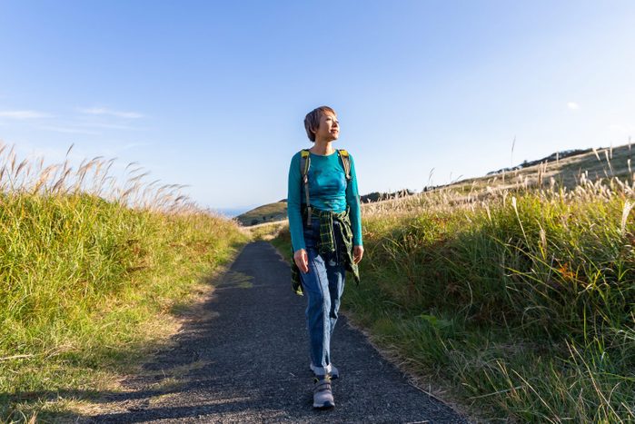 A woman hiking in the mountains in the fall