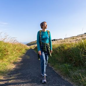 A woman hiking in the mountains in the fall