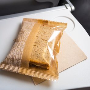 Close-Up Of a Sandwich on an airplane table