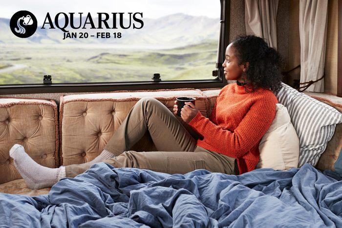 woman looking out the back window of her camper van