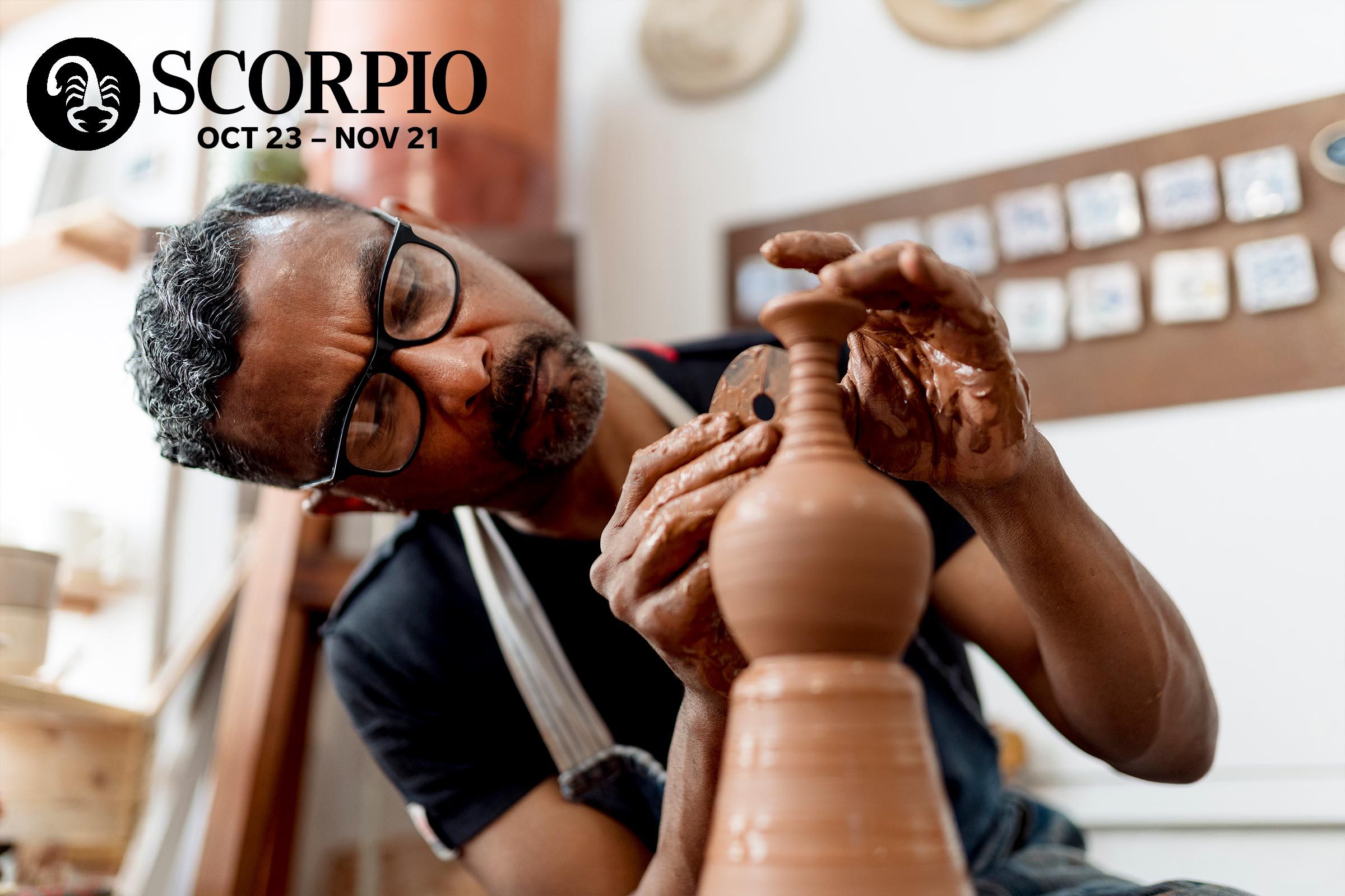 a man working with clay on a wheel