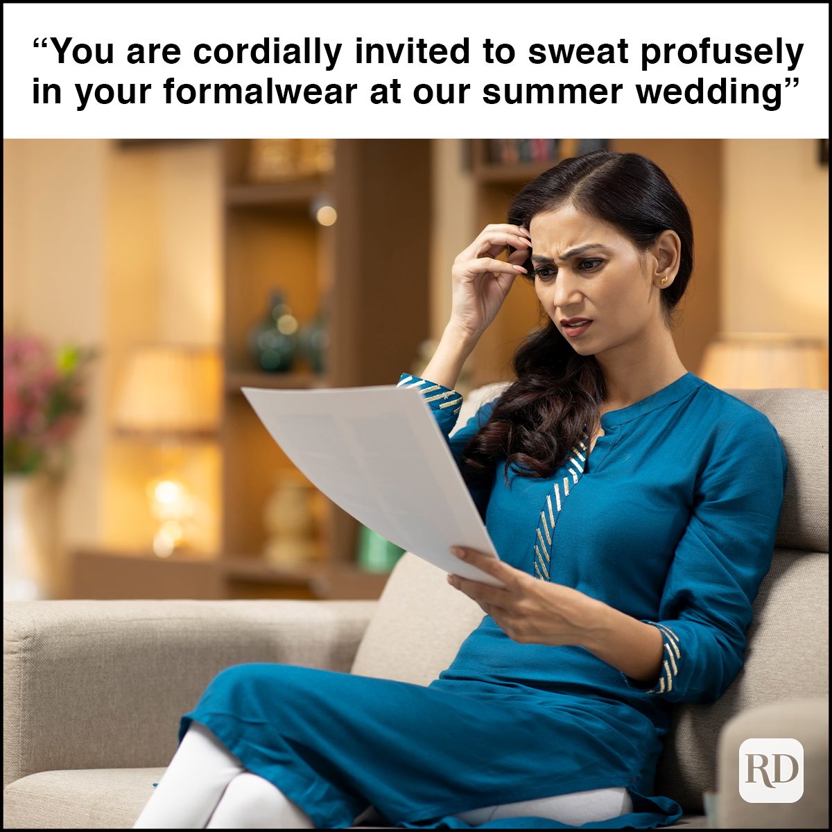 Suspicious female reading a letter sitting on a couch in the living room at home In Green Sunglasses Showing A Rock Gesture Isolated On White Background