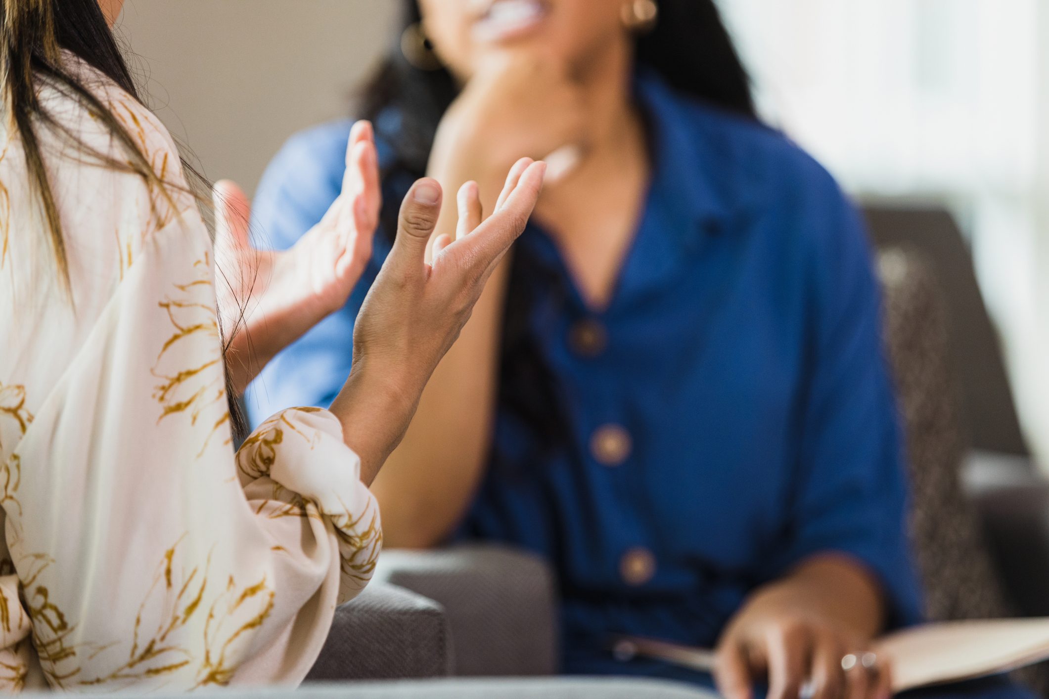 Unrecognizable woman talking with friend