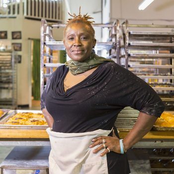 Black baker standing in bakery kitchen