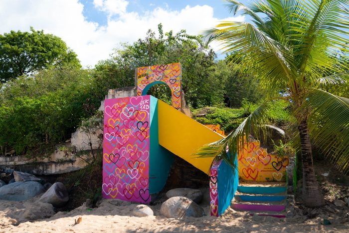 whimsical wall art on a stone staircase at a beach in saint martin