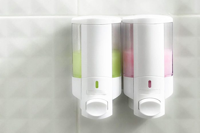 Shower and shampoo bottle on wall