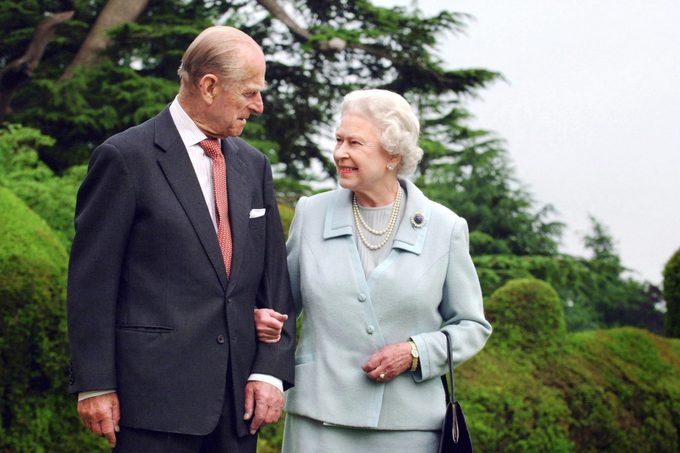 TOPSHOT - Picture released 18 November 2007 shows Britain's Queen Elizabeth II and her husband, the Duke of Edinburgh walk at Broadlands, Hampshire, earlier in the year. - Queen Elizabeth II and Prince Philip are to mark their diamond wedding anniversary in reserved style 19 November 2007 before jetting off to Malta to revive golden memories of their newlywed youth. Queen Elizabeth, 81, is known to cherish the time they spent on the Mediterranean island as a young couple, out of Britain and out of the spotlight in the years before she inherited the throne aged 25 in 1952. (Photo by Fiona HANSON / POOL / AFP) (Photo by FIONA HANSON/POOL/AFP via Getty Images)