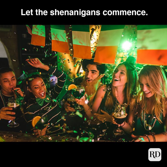 Happy multi-ethnic friends drinking and having fun at Saint Patrick's day night club party