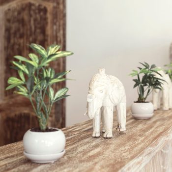 Figures Of Elephants sitting on the ledge of a home