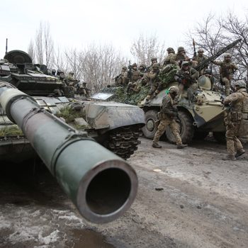 Ukrainian servicemen with tanks get ready to repel an attack in Ukraine's Lugansk region on February 24, 2022.