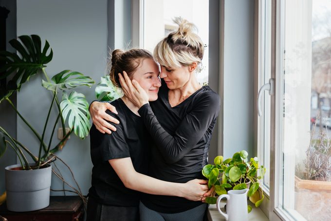 Single Mom Affectionately Hugging Teenage Daughter