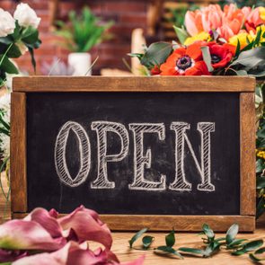 Open sign among flowers for easter