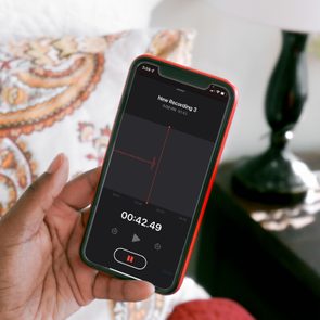 Woman Holds iphone recording a voice memo