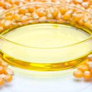 corn syrup in a petri dish surrounded by corn kernals