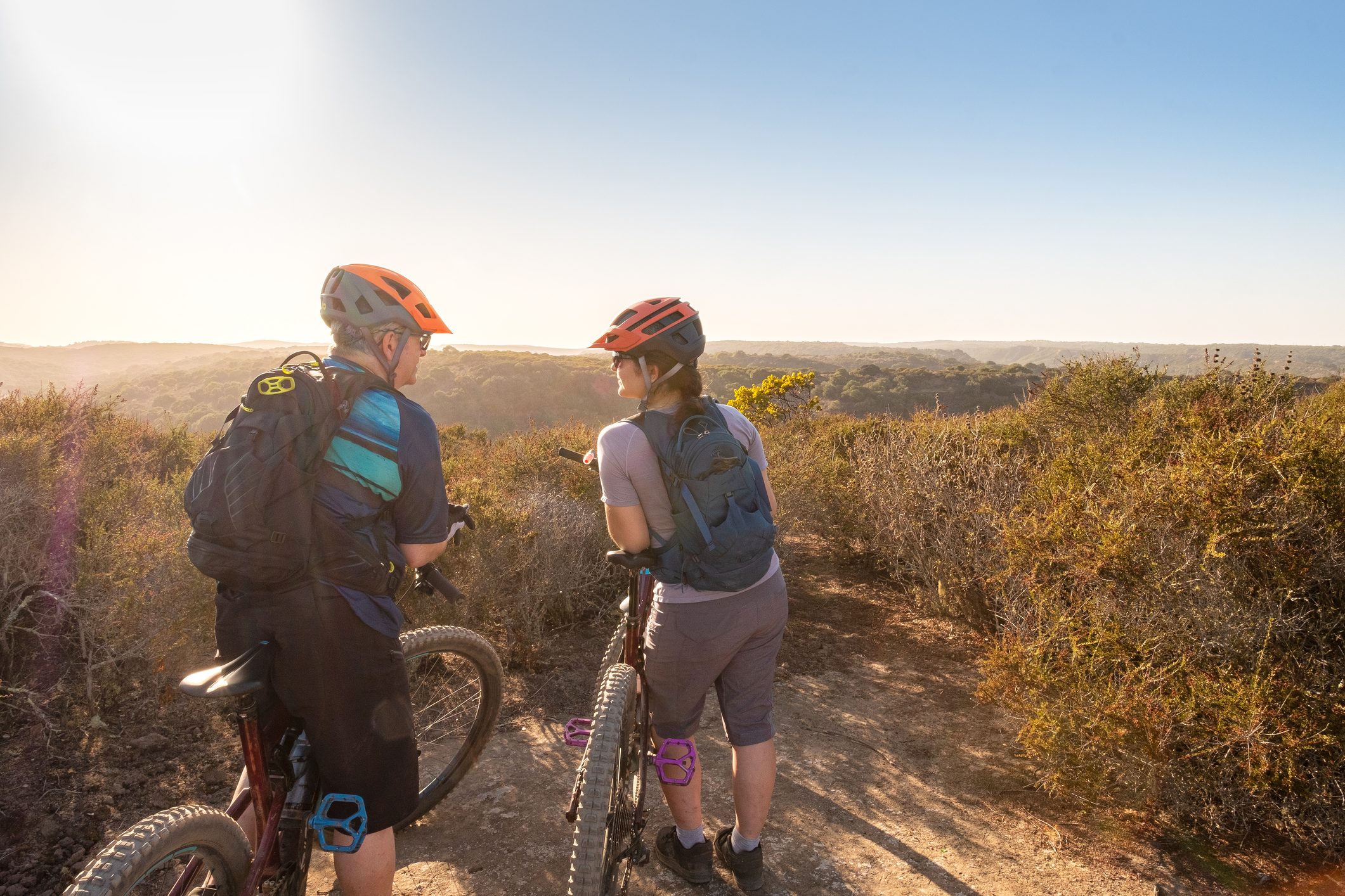 Father and Daughter Mountain Bikers Enjoy Summer Mountaintop View, California