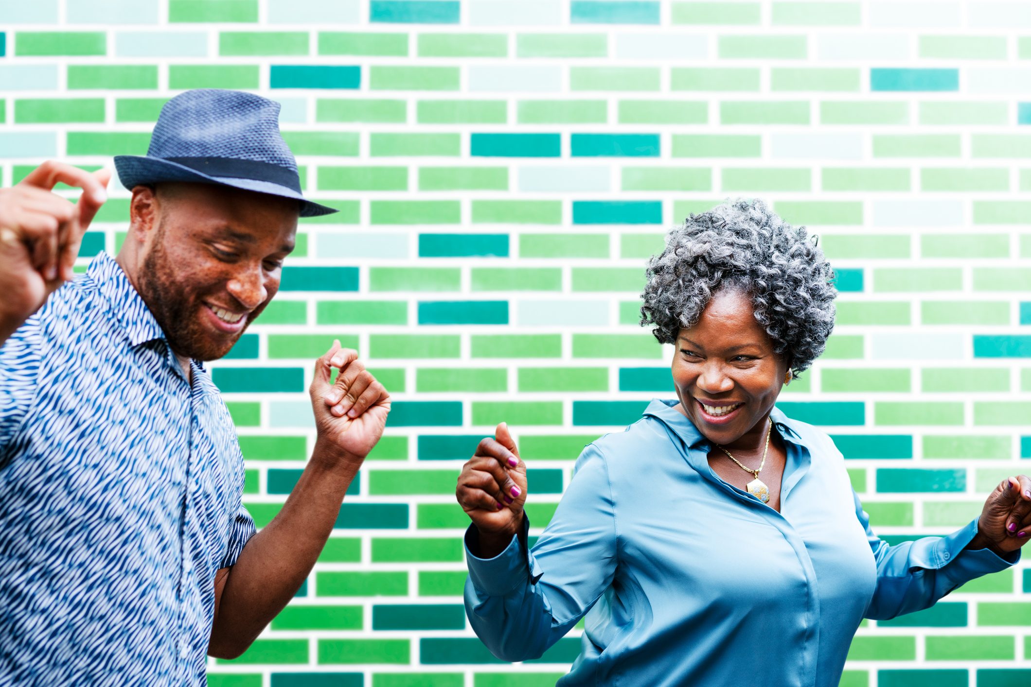 Man and woman dancing next to wall