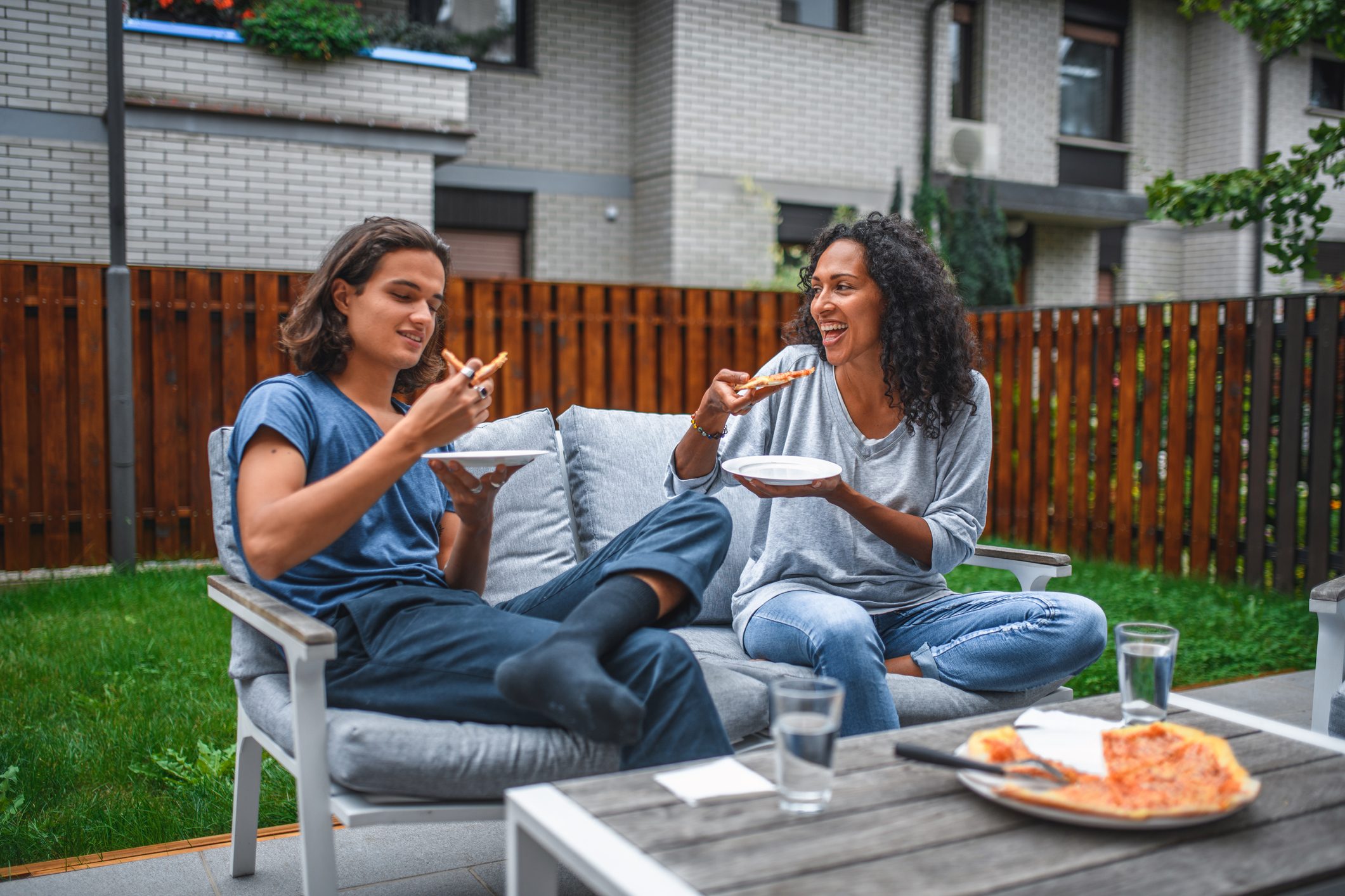 Hispanic Mother and Son Eating Pizza Outdoors