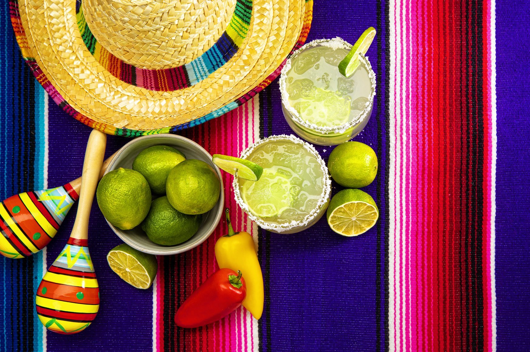 Happy Cinco de Mayo with two Margarita Glasses on a Colorful Mexican Blanket