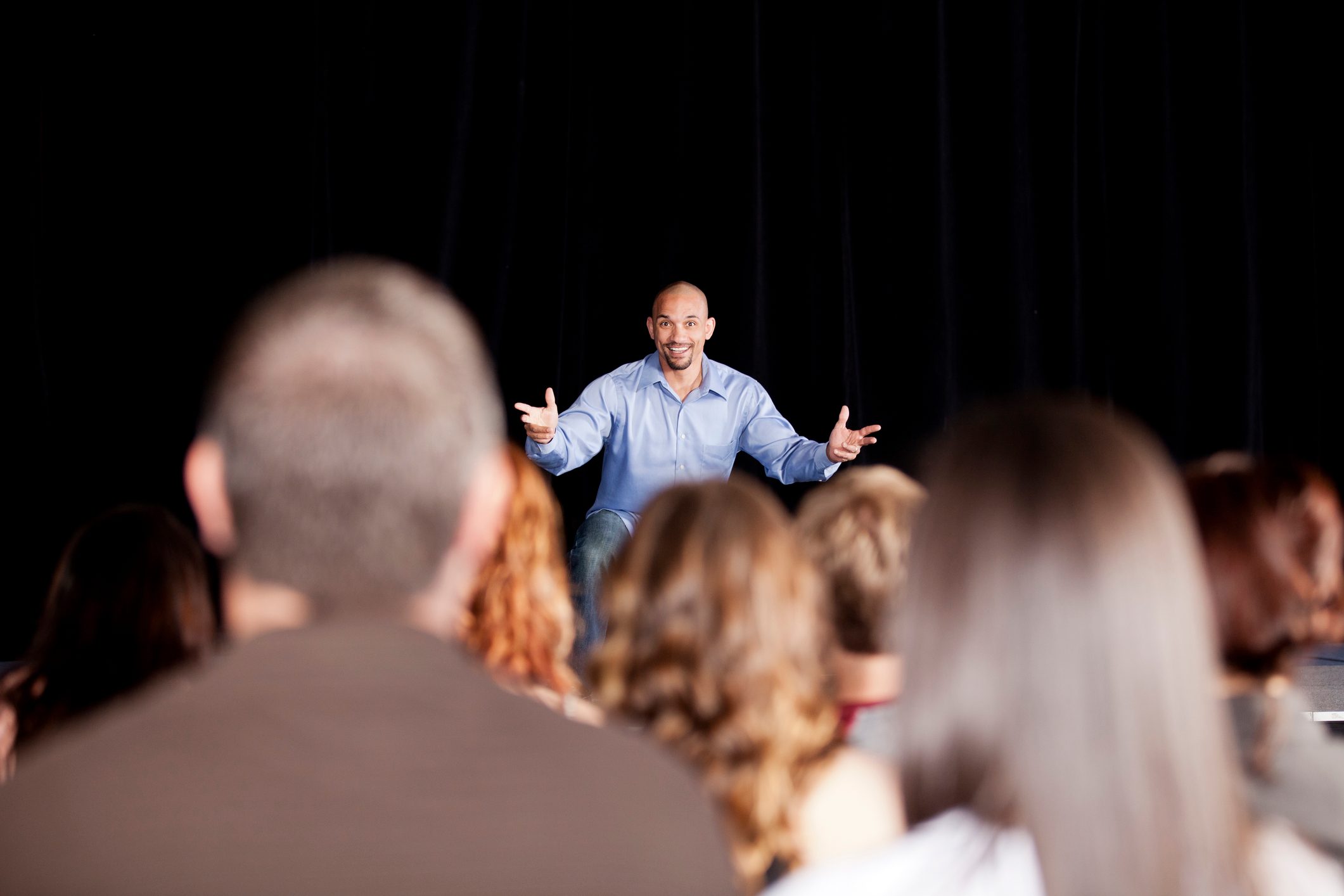 Young man performing on stage for an audience