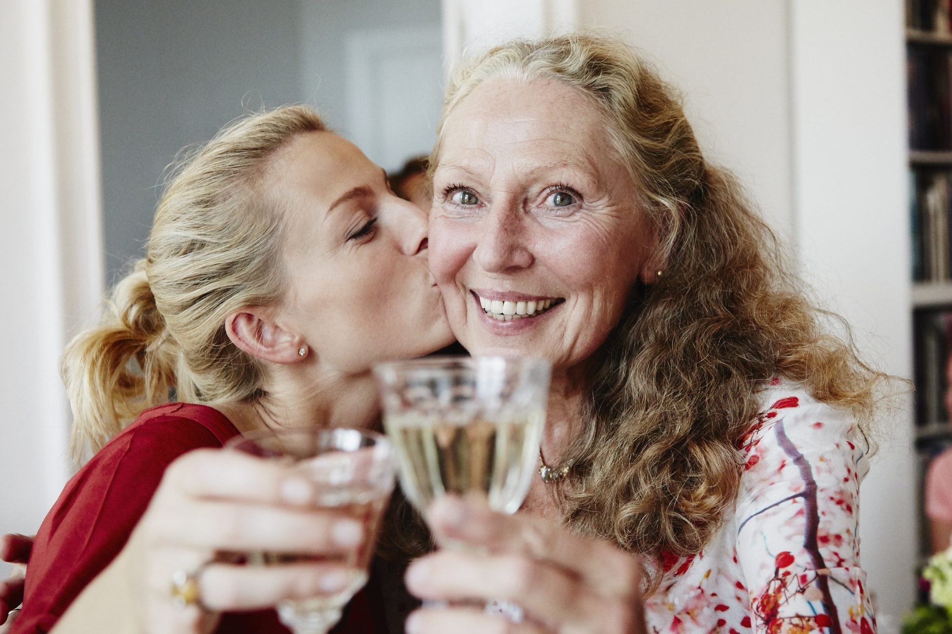 happy friends raise a glas of sparkling wine at a party